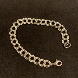 Solid silver charm bracelet, 7” long.